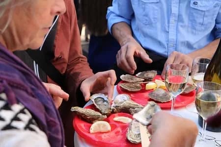 Eating Oysters - 1EarthMedia Montmartre Grape Harvest Wine Festival © Mark Anning photo 2022