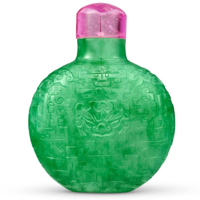 Snuff Bottle Christies - 1EarthMedia Green round perfume bottle with an ornate embossed pattern and a pink/purple cap.